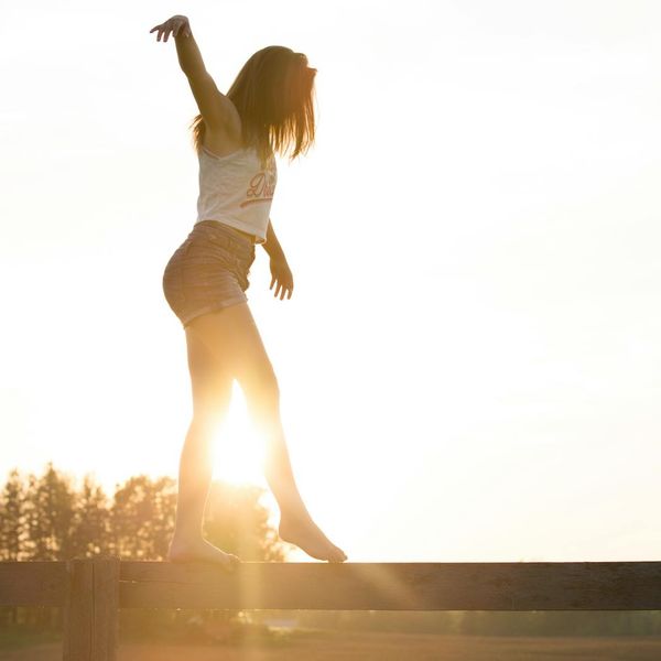 Silhouette of a person feeling energetic against a sunrise.